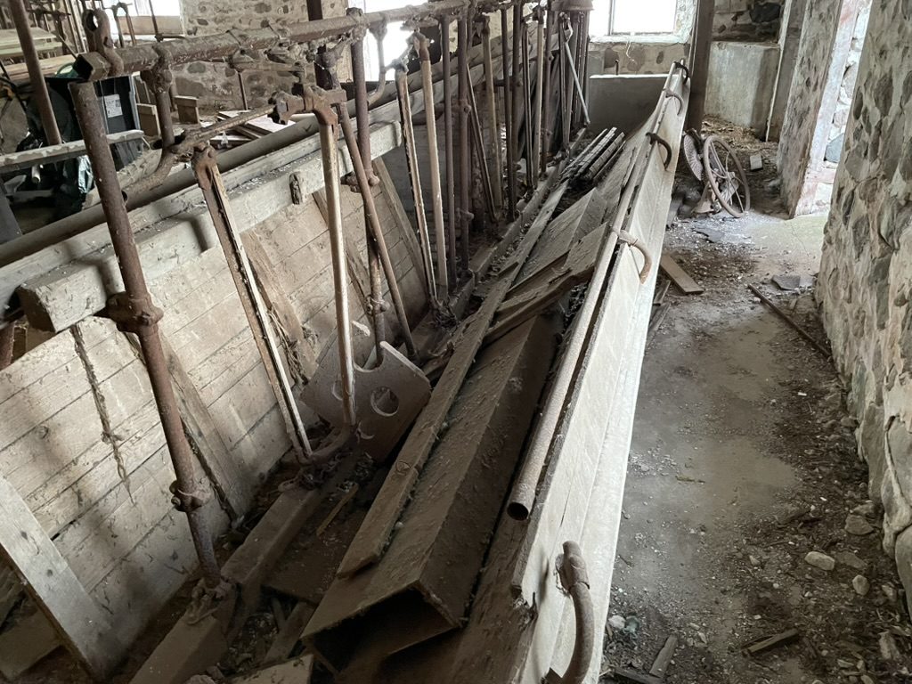 Old dairy barn with stanchions cleaned out in rural Wisconsin