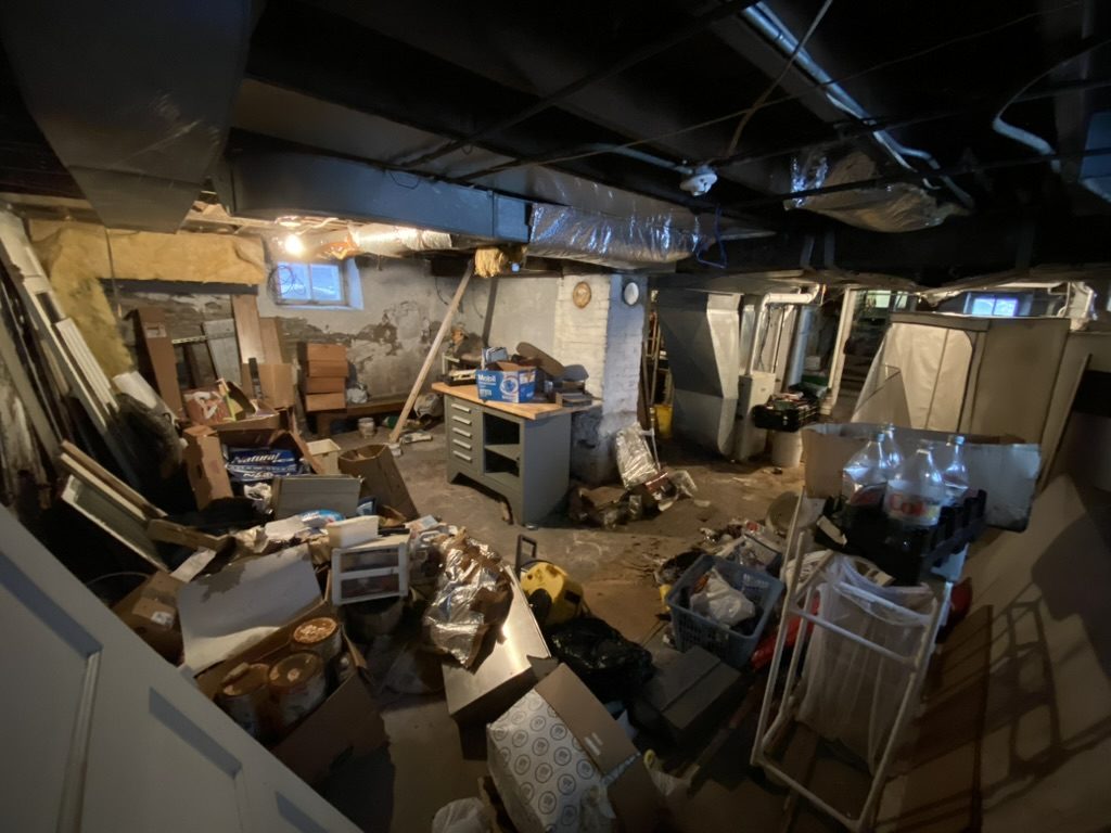 Packed basement full of junk before cleanout in Fox Valley WI