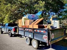 Dump trailer loaded with junk - medium capacity compared to professional junk truck