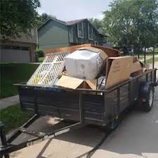 Small utility trailer loaded with junk - lowest capacity for full load