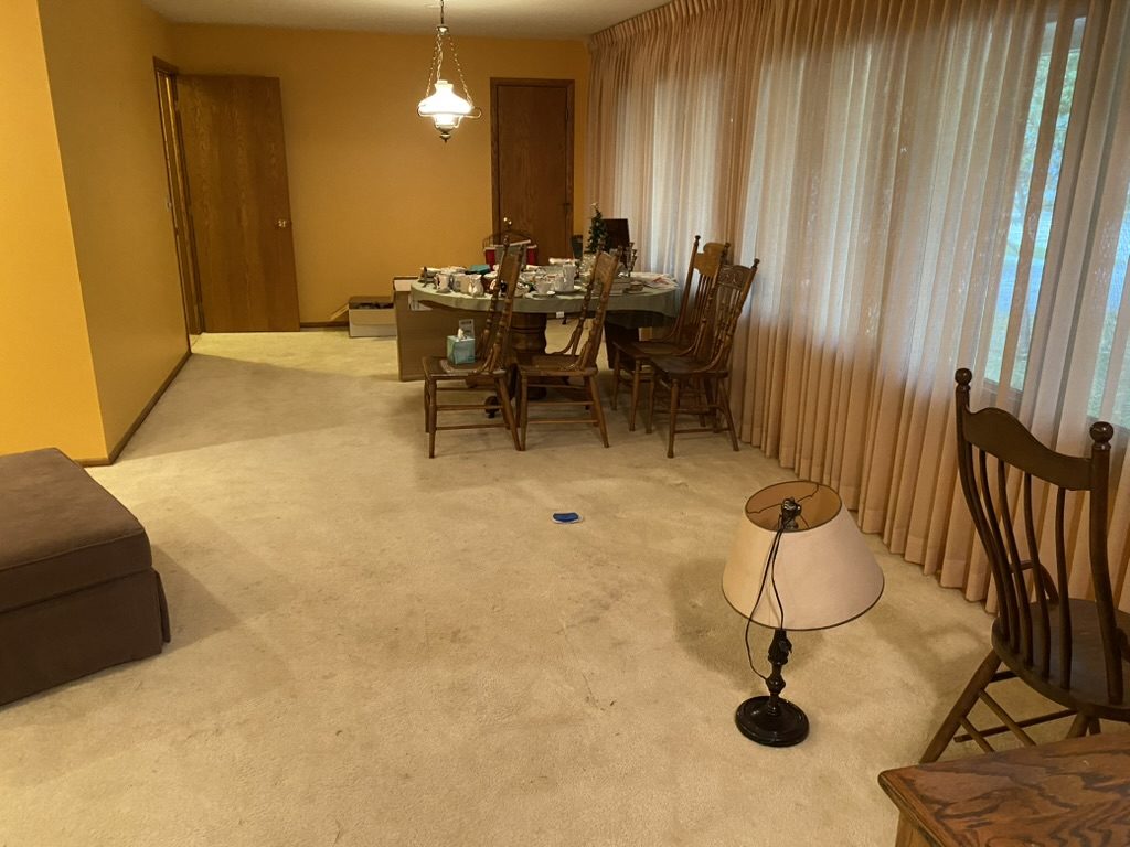 Dining room before estate cleanout - table and furniture removal