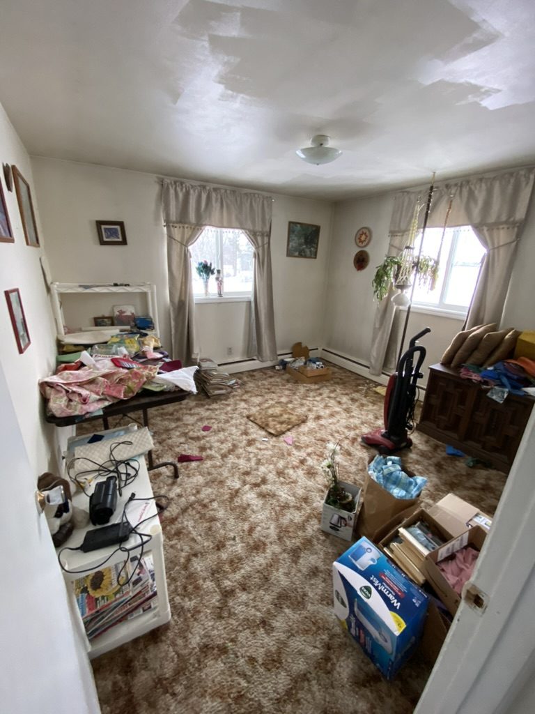 Cluttered living room before estate cleanout in Fox Valley